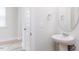 Classic bathroom with pedestal sink and round mirror at 576 Barbour Farm Ln, Four Oaks, NC 27524