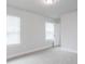 Bedroom with two windows providing natural light and a door leading to another room at 576 Barbour Farm Ln, Four Oaks, NC 27524