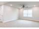 Spacious bonus room with plush carpeting, neutral walls, and a ceiling fan at 576 Barbour Farm Ln, Four Oaks, NC 27524