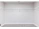 Walk-in closet featuring white wire shelving with neutral carpeting at 576 Barbour Farm Ln, Four Oaks, NC 27524