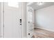 Front door opens to reveal a bright and airy foyer with hardwood floors and stylish glass french doors at 576 Barbour Farm Ln, Four Oaks, NC 27524