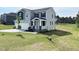 Beautiful two-story home with a well-maintained lawn on a sunny day and a view of a golf course at 576 Barbour Farm Ln, Four Oaks, NC 27524