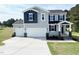Charming two-story home featuring a three-car garage and manicured lawn, perfect for Gathering living at 576 Barbour Farm Ln, Four Oaks, NC 27524