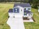 Charming two-story home with a wide driveway and a lush green lawn at 576 Barbour Farm Ln, Four Oaks, NC 27524