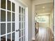 Elegant foyer featuring hardwood floors, bright lighting, and stylish French doors leading to an office at 576 Barbour Farm Ln, Four Oaks, NC 27524