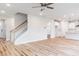 Welcoming foyer featuring hardwood floors, staircase, and open access to the kitchen and other living areas at 576 Barbour Farm Ln, Four Oaks, NC 27524