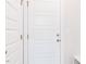 Hallway shot with a five panel door, neutral colors, and simple architectural details at 576 Barbour Farm Ln, Four Oaks, NC 27524