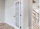 Bright hallway with French doors, leading to a living area with staircase at 576 Barbour Farm Ln, Four Oaks, NC 27524