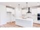 Bright and airy kitchen with an island, stainless steel appliances, and sleek white cabinetry at 576 Barbour Farm Ln, Four Oaks, NC 27524