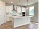 Bright kitchen featuring stainless appliances, an island with quartz countertops, and white subway tile backsplash at 576 Barbour Farm Ln, Four Oaks, NC 27524