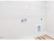 Unfinished laundry room with white walls, plank flooring, hookups, and overhead rack for optimal storage at 576 Barbour Farm Ln, Four Oaks, NC 27524