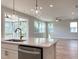 Living space and kitchen featuring hardwood flooring and lots of natural light at 576 Barbour Farm Ln, Four Oaks, NC 27524