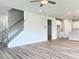 Bright, spacious living room with wood floors, staircase, and an open layout to the kitchen, perfect for entertaining at 576 Barbour Farm Ln, Four Oaks, NC 27524