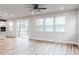 Open-concept living room with hardwood floors, recessed lighting, and access to a screened-in porch overlooking the golf course at 576 Barbour Farm Ln, Four Oaks, NC 27524