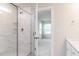 Bathroom shower stall with marble tile and a partial view into the bedroom at 576 Barbour Farm Ln, Four Oaks, NC 27524