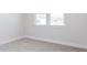 Carpeted bedroom with base molding, and windows with a backyard view at 644 Barbour Farm Ln, Four Oaks, NC 27524
