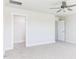 Spacious bedroom featuring neutral carpeting, a ceiling fan, and an adjacent walk-in closet at 644 Barbour Farm Ln, Four Oaks, NC 27524