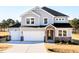 Charming home with a two-car garage, stone entryway, and a well-manicured lawn at 644 Barbour Farm Ln, Four Oaks, NC 27524