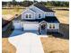Aerial view of home with a three-car garage and expansive, well-manicured front lawn at 644 Barbour Farm Ln, Four Oaks, NC 27524