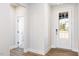 Bright foyer with wood floors, white trim, and a clear-paneled front door at 644 Barbour Farm Ln, Four Oaks, NC 27524