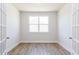 Sunlit room with wood floors, white walls, and elegant french doors at 644 Barbour Farm Ln, Four Oaks, NC 27524