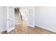 Open-concept living area with wood floors, french doors, and staircase access to upper floor at 644 Barbour Farm Ln, Four Oaks, NC 27524