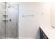 Tiled walk-in shower with a glass door featuring a built-in shelf and shower head at 644 Barbour Farm Ln, Four Oaks, NC 27524