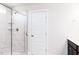 Bathroom showcasing a tiled shower with glass door and a modern, five-panel door at 674 Barbour Farm Ln, Four Oaks, NC 27524
