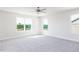 Bedroom features carpet, two windows with natural light and a ceiling fan, creating an inviting living space at 674 Barbour Farm Ln, Four Oaks, NC 27524
