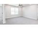 Bedroom features carpet, large window and a ceiling fan, creating an inviting living space at 674 Barbour Farm Ln, Four Oaks, NC 27524
