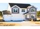 Well-maintained two-story home with gray and white siding and a spacious two-car garage at 674 Barbour Farm Ln, Four Oaks, NC 27524