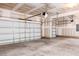 Spacious garage with concrete floor and white doors at 674 Barbour Farm Ln, Four Oaks, NC 27524