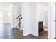 Hallway features dark wood floors, a staircase, and glimpses of a bathroom, showcasing the interior at 674 Barbour Farm Ln, Four Oaks, NC 27524