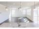 Sun-filled living room with hardwood floors, modern lighting, and an open floor plan at 674 Barbour Farm Ln, Four Oaks, NC 27524