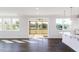 Bright living room boasts dark wood floors, white walls, and sliding door to a screened-in porch at 674 Barbour Farm Ln, Four Oaks, NC 27524