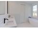 Modern bathroom with double vanity, white subway tile, and free-standing tub at 8780 Old Nc 86, Chapel Hill, NC 27516
