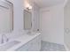 Double vanity bathroom with white cabinets and patterned floor at 8780 Old Nc 86, Chapel Hill, NC 27516