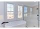 Bright bathroom with soaking tub, walk-in shower, and large windows at 8780 Old Nc 86, Chapel Hill, NC 27516
