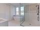 Spa-like bathroom featuring a freestanding tub and a glass-enclosed shower at 8780 Old Nc 86, Chapel Hill, NC 27516