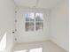Bright bedroom with large window, carpet, and neutral walls at 8780 Old Nc 86, Chapel Hill, NC 27516