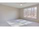 Bright bedroom with large window, wood-look floors, and shiplap wall at 8780 Old Nc 86, Chapel Hill, NC 27516