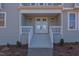 Front entrance with double doors and white railings at 8780 Old Nc 86, Chapel Hill, NC 27516