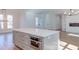 Large kitchen island with white quartz countertop and built-in microwave at 8780 Old Nc 86, Chapel Hill, NC 27516