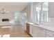White kitchen with stainless steel appliances and view into living area at 8780 Old Nc 86, Chapel Hill, NC 27516