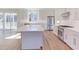 Kitchen with island, stainless steel appliances, and hardwood floors at 8780 Old Nc 86, Chapel Hill, NC 27516