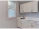 Laundry room with white cabinets and quartz countertop at 8780 Old Nc 86, Chapel Hill, NC 27516