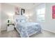 Bright bedroom with a comfortable bed, decorative artwork, and a window offering a pleasant view at 1581 Ivy Meadow Ln, Zebulon, NC 27597