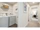 Convenient laundry room with washer, dryer, shelving, and easy access to hallway at 1581 Ivy Meadow Ln, Zebulon, NC 27597