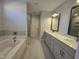 Modern bathroom with double vanity and soaking tub at 1109 Prominence Dr., Homesite 17, Durham, NC 27712