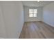 Spacious bedroom with hardwood floors and large window at 1109 Prominence Dr., Homesite 17, Durham, NC 27712